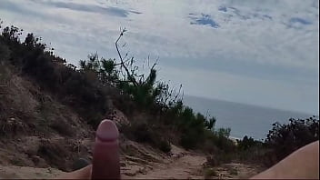 Guy on nude beach spills a lot of milk