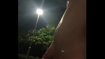 Asian wandering in park naked